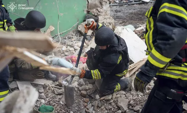 In this photo provided by the Ukrainian Emergency Services on Nov. 19, 2024, rescue workers clear the rubble of a residential building destroyed by a Russian strike in Hlukhiv, Ukraine. (Ukrainian Emergency Service via AP)