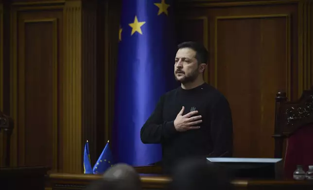 In this photo provided by the Press Service Of The President Of Ukraine on Nov. 19, 2024, Ukraine's President Volodymyr Zelenskyy listens to the national anthem before his speech at Verkhovna Rada in Kyiv, Ukraine. (Press Service Of The President Of Ukraine via AP)