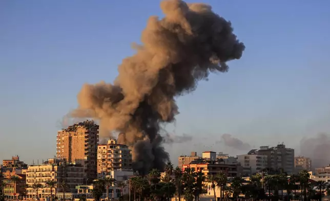 Smoke rises from a building hit in an Israeli airstrike in Tyre, southern Lebanon, Saturday, Nov. 16, 2024. (AP Photo/Mohammed Zaatari)