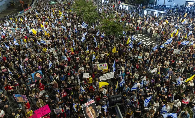 People gather to protest against Prime Minister Benjamin Netanyahu's government and call for the release of hostages held in the Gaza Strip by the Hamas militant group, in Tel Aviv, Israel, Saturday, Nov. 16, 2024. (AP Photo/Francisco Seco)