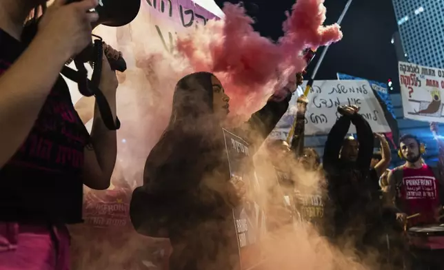 People shout slogans during a protest against Prime Minister Benjamin Netanyahu's government and call for the release of hostages held in the Gaza Strip by the Hamas militant group, in Tel Aviv, Israel, Saturday, Nov. 16, 2024. (AP Photo/Francisco Seco)