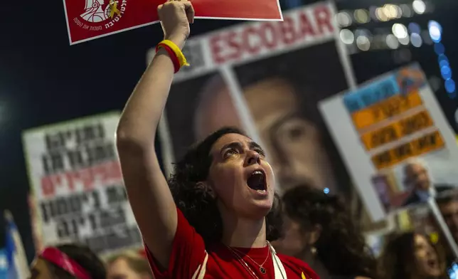 A woman shouts slogans during a protest against Prime Minister Benjamin Netanyahu's government and call for the release of hostages held in the Gaza Strip by the Hamas militant group, in Tel Aviv, Israel, Saturday, Nov. 16, 2024. (AP Photo/Francisco Seco)