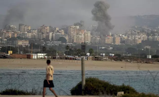 Smokes rise from buildings hit in Israeli airstrikes in Tyre, southern Lebanon, Saturday, Nov. 16, 2024. (AP Photo/Mohammed Zaatari)