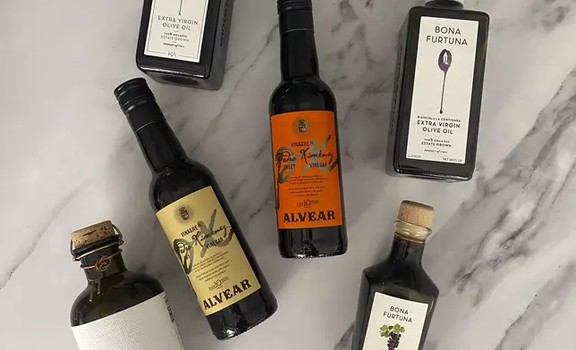 This image provided by Katie Workman shows a selection of olive oil and vinegars. (Katie Workman via AP)