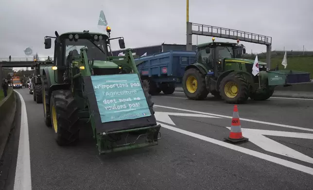 Farmers block a speedway to protest the EU-Mercosur trade agreement, Monday, Nov. 18, 2024 in Velizy-Villacoublay outside Paris. (AP Photo/Christophe Ena)