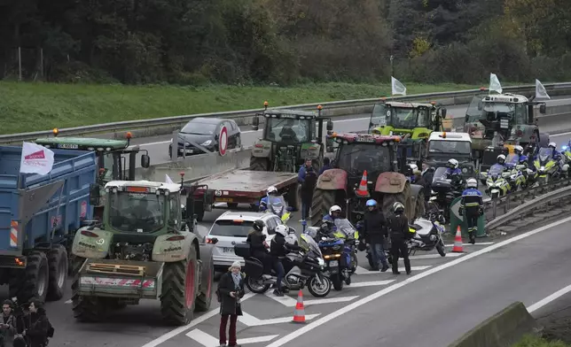 Farmers block a speedway to protest the EU-Mercosur trade agreement, Monday, Nov. 18, 2024 in Velizy-Villacoublay outside Paris. (AP Photo/Christophe Ena)