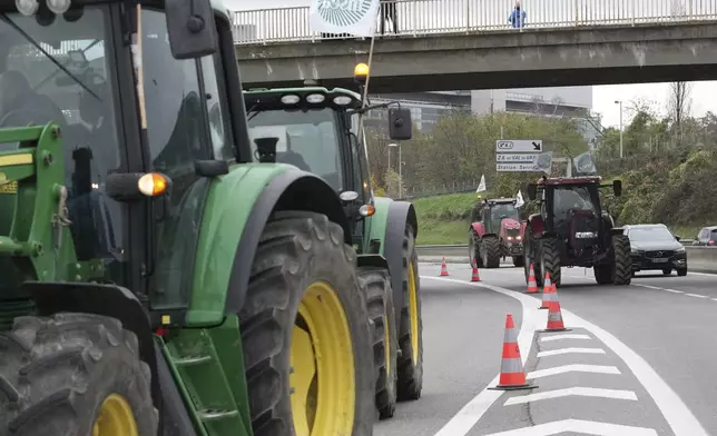 Farmers block a speedway to protest the EU-Mercosur trade agreement, Monday, Nov. 18, 2024 in Velizy-Villacoublay outside Paris. (AP Photo/Christophe Ena)