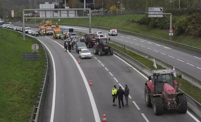 Farmers block a speedway to protest the EU-Mercosur trade agreement, Monday, Nov. 18, 2024 in Velizy-Villacoublay outside Paris. (AP Photo/Christophe Ena)