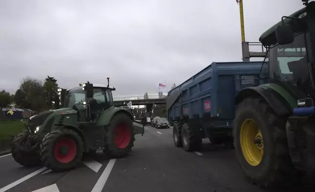 Farmers block a speedway to protest the EU-Mercosur trade agreement, Monday, Nov. 18, 2024 in Velizy-Villacoublay outside Paris. (AP Photo/Christophe Ena)