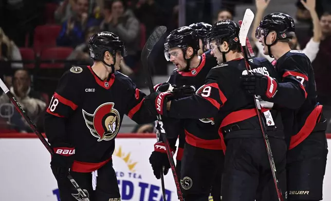 Ottawa Senators right wing Drake Batherson, second from left, celebrates after his goal against the Philadelphia Flyers with center Tim Stutzle (18) during second-period NHL hockey game action in Ottawa, Ontario, Thursday, Nov. 14, 2024. (Justin Tang/The Canadian Press via AP)