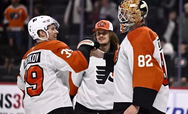 Philadelphia Flyers right wing Matvei Michkov (39) celebrates with goaltender Ivan Fedotov (82) after defeating the Ottawa Senators in overtime of an NHL hockey game, Thursday, Nov. 14, 2024 in Ottawa, Ontario. (Justin Tang/The Canadian Press via AP)