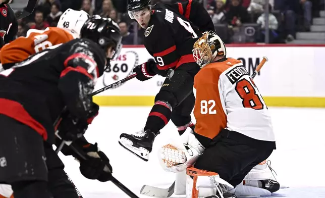 Philadelphia Flyers goaltender Ivan Fedotov (82) makes a save as Ottawa Senators center Josh Norris (9) looks for a rebound during the second period of an NHL hockey game, Thursday, Nov. 14, 2024 in Ottawa, Ontario. (Justin Tang/The Canadian Press via AP)