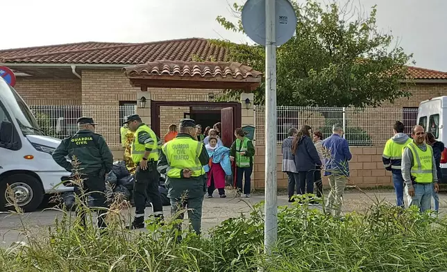 Residents are moved out of the nursing home where least 10 people have died in a fire in Zaragoza, Spain, Friday, Nov. 15, 2024. (AP Photo/Ferran Mallol )