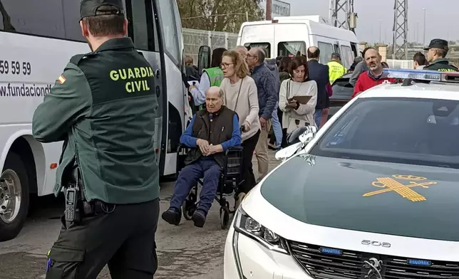 Residents are moved out of the nursing home where least 10 people have died in a fire in Zaragoza, Spain, Friday, Nov. 15, 2024. (AP Photo/Ferran Mallol )