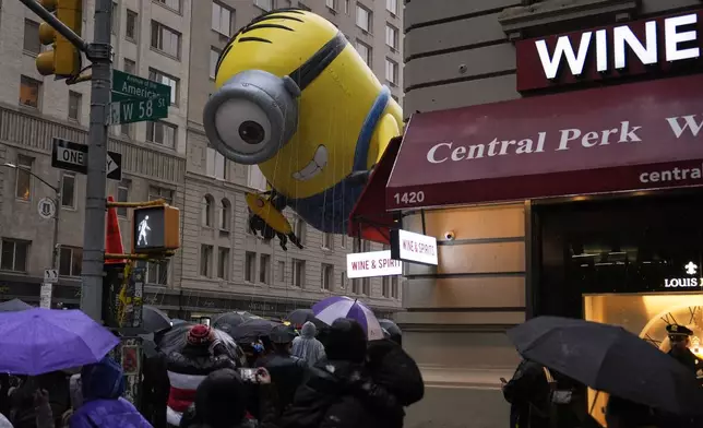 Handlers pull the Stuart the Minion balloon down Sixth Avenue during the Macy's Thanksgiving Day Parade, Thursday, Nov. 28, 2024, in New York. (AP Photo/Julia Demaree Nikhinson)