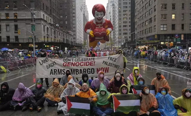 Pro-Palestinian protesters demonstrate on Sixth Avenue during the Macy's Thanksgiving Day Parade, Thursday, Nov. 28, 2024, in New York. (AP Photo/Julia Demaree Nikhinson)