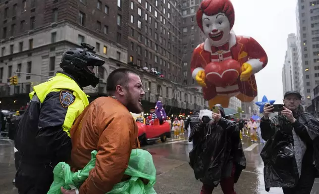 New York Police arrest Pro-Palestinian protesters who were demonstrating on Sixth Avenue during the Macy's Thanksgiving Day Parade, Thursday, Nov. 28, 2024, in New York. (AP Photo/Julia Demaree Nikhinson)