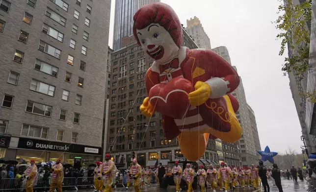 Handlers pull the Ronald McDonald balloon down Sixth Avenue during the Macy's Thanksgiving Day Parade, Thursday, Nov. 28, 2024, in New York. (AP Photo/Julia Demaree Nikhinson)