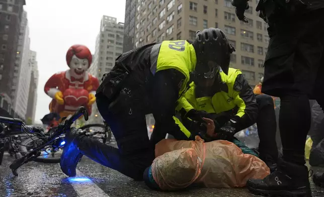 New York Police arrest Pro-Palestinian protesters who were demonstrating on Sixth Avenue during the Macy's Thanksgiving Day Parade, Thursday, Nov. 28, 2024, in New York. (AP Photo/Julia Demaree Nikhinson)