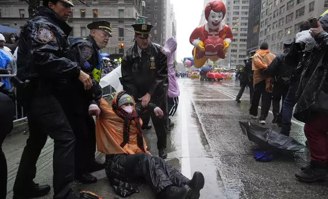 New York Police arrest Pro-Palestinian protesters who were demonstrating on Sixth Avenue during the Macy's Thanksgiving Day Parade, Thursday, Nov. 28, 2024, in New York. (AP Photo/Julia Demaree Nikhinson)