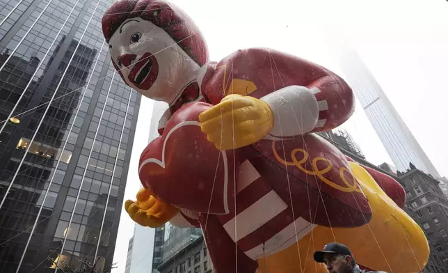 Handlers guide the Ronald McDonald balloon down Sixth Avenue during the Macy's Thanksgiving Day Parade, Thursday, Nov. 28, 2024, in New York. (AP Photo/Julia Demaree Nikhinson)