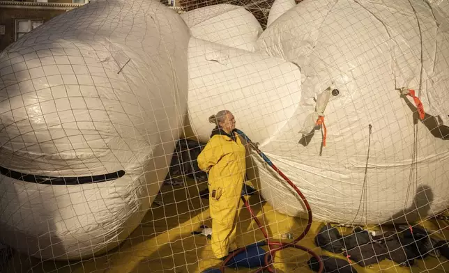 A person inflates a float in preparation for the Macy's Thanksgiving Day Parade, Wednesday, Nov. 27, 2024, in New York. (AP Photo/Yuki Iwamura)