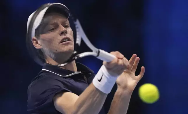 Italy's Jannik Sinner returns the ball to Russia's Daniil Medvedev during their singles tennis match of the ATP World Tour Finals at the Inalpi Arena, in Turin, Italy, Thursday, Nov. 14, 2024. (AP Photo/Antonio Calanni)