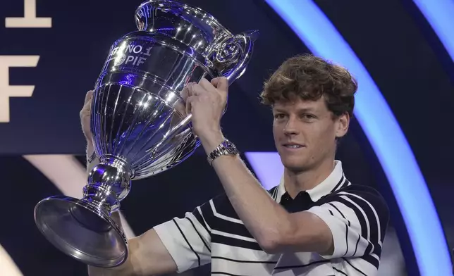 Italy's Jannik Sinner holds the trophy as ATP world best player at the ATP World Tour Finals at the Inalpi Arena, in Turin, Italy, Monday, Nov. 11, 2024. Sinner was presented with the trophy for finishing the year ranked No. 1. (AP Photo/Antonio Calanni)