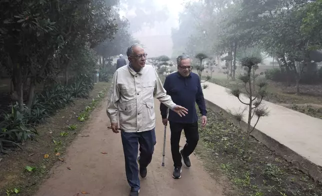 Rajiv Sikri, left, and Subodh Jain take a morning walk in Lodhi Gardens in New Delhi, India, Friday, Nov. 15, 2024. (AP Photo/Manish Swarup)