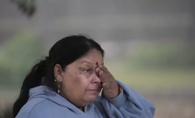 Vanita Pathak wipes her tears as she gets emotional talking about her love for nature, in the smog-enveloped Lodhi Gardens in New Delhi, India, Friday, Nov. 15, 2024. (AP Photo/Manish Swarup)