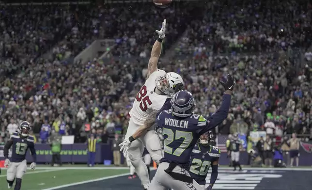 Arizona Cardinals tight end Trey McBride (85) is unable to make a catch in the endzone on the third down as Seattle Seahawks cornerback Riq Woolen (27) defends during the second half of an NFL football game Sunday, Nov. 24, 2024, in Seattle. (AP Photo/Stephen Brashear)