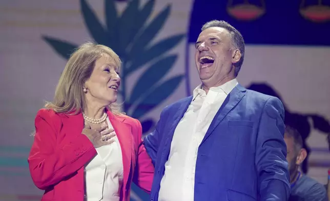 Yamandu Orsi, candidate for the Broad Front (Frente Amplio), and running mate Carolina Cosse, left, celebrate their victory in the presidential run-off election in Montevideo, Uruguay, Sunday, Nov. 24, 2024. (AP Photo/Natacha Pisarenko)