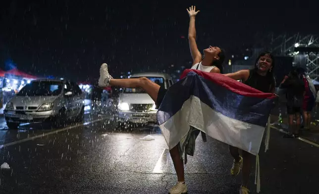 Supporters of the Frente Amplio (Broad Front) celebrate the victory of candidate Yamandú Orsi in the presidential run-off election in Montevideo, Uruguay, Sunday, Nov. 24, 2024. (AP Photo/Natacha Pisarenko)