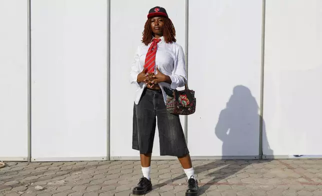 A woman dressed in second-hand clothes attends a thrift and an upcycle show in Accra, Ghana, Sunday, Oct. 27, 2024. (AP Photo/Misper Apawu)