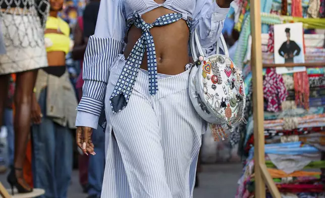 A model dressed in an upcycled outfit poses during a thrift and an upcycle show in Accra, Ghana, Sunday, Oct. 27, 2024. (AP Photo/Misper Apawu)