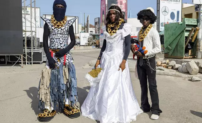 Attendees at a thrift and an upcycle show pose for a photograph in Accra, Ghana, Sunday, Oct. 27, 2024. (AP Photo/Misper Apawu)