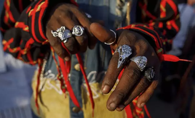 A model shows thrift rings during a thrift and an upcycle show in Accra, Ghana, Sunday, Oct. 27, 2024. (AP Photo/Misper Apawu)