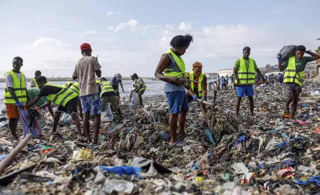 Volunteers and workers for the OR Foundation partake in a beach clean up at Jamestown in Accra, Ghana, Saturday, Oct. 19, 2024. (AP Photo/Misper Apawu)