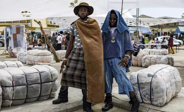 Attendees pose for a photograph during a thrift and an upcycle show in Accra, Ghana, Sunday, Oct. 27, 2024. (AP Photo/Misper Apawu)