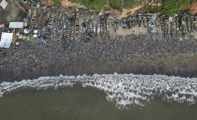 Textile waste pollutes the beach shore at Jamestown in Accra, Ghana, Saturday, Oct. 19, 2024. (AP Photo/Misper Apawu)