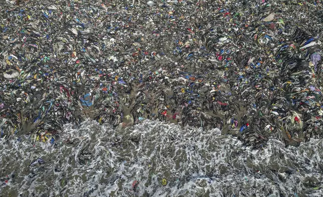 Textile waste pollutes the beach shore at Jamestown in Accra, Ghana, Saturday, Oct. 19, 2024. (AP Photo/Misper Apawu)