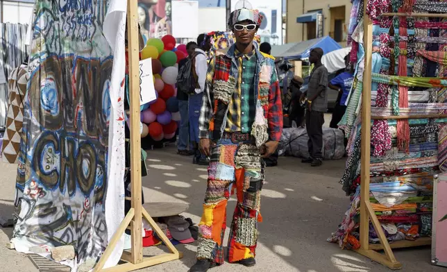 A man dressed in an upcycled outfit poses for a photograph during a thrift and an upcycle show in Accra, Ghana, Sunday, Oct. 27, 2024. (AP Photo/Misper Apawu)