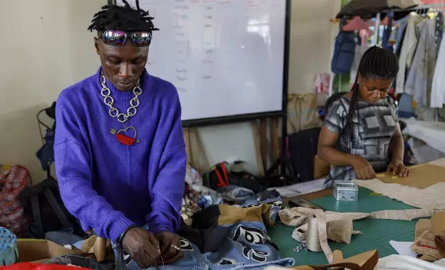 Designers work in the remanufacturing space at the OR Foundation to upcycle textile waste in Accra, Ghana, Thursday, Oct. 24, 2024. (AP Photo/Misper Apawu)