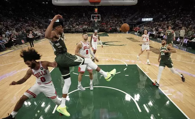 Milwaukee Bucks' Giannis Antetokounmpo dunks past Chicago Bulls' Zach LaVine and Coby White during the second half of an NBA basketball game Wednesday, Nov. 20, 2024, in Milwaukee. Tyhe Bucks won 122-106. (AP Photo/Morry Gash)