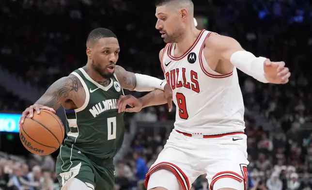 Milwaukee Bucks' Damian Lillard tries to get past Chicago Bulls' Nikola Vucevic during the second half of an NBA basketball game Wednesday, Nov. 20, 2024, in Milwaukee. Tyhe Bucks won 122-106. (AP Photo/Morry Gash)