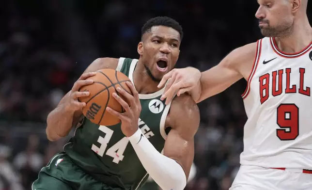 Milwaukee Bucks' Giannis Antetokounmpo drives on Chicago Bulls' Nikola Vucevic during the second half of an NBA basketball game Wednesday, Nov. 20, 2024, in Milwaukee. Tyhe Bucks won 122-106. (AP Photo/Morry Gash)