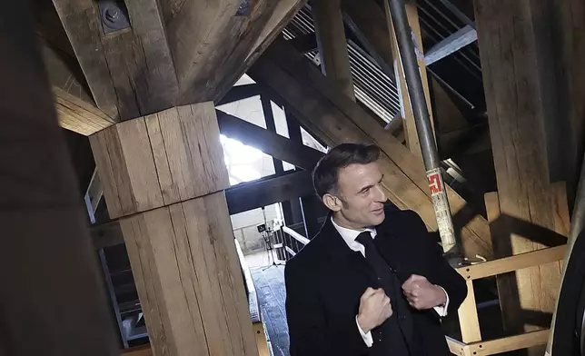 French President Emmanuel Macron gestures as he visits the restored interiors of the Notre-Dame de Paris cathedral, Friday, Nov.29, 2024 in Paris. (Christophe Petit Tesson, Pool via AP)