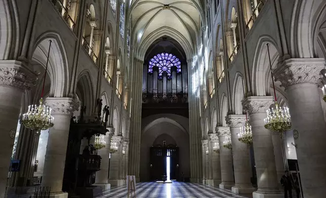 The nave, the western Rose window and the organ of Notre-Dame de Paris cathedral are seen while French President Emmanuel Macron visits the restored interiors of the monument, Friday Nov. 29, 2024, in Paris. (Stephane de Sakutin, Pool via AP)