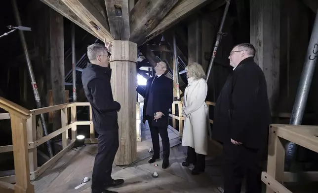 French President Emmanuel Macron, third right, and his wife Brigitte Macron visit the restored interiors of the Notre-Dame de Paris cathedral, Friday, Nov.29, 2024 in Paris. (Christophe Petit Tesson, Pool via AP)
