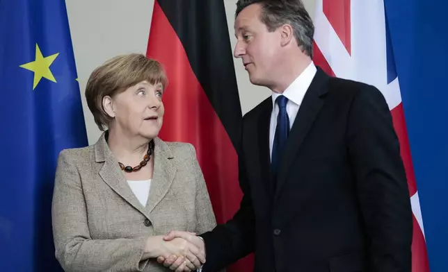 FILE - German Chancellor Angela Merkel, left, and British Prime Minister David Cameron shake hands after a news conference following a meeting at the chancellery in Berlin, Germany, Friday, May 29, 2015. (AP Photo/Markus Schreiber, File)